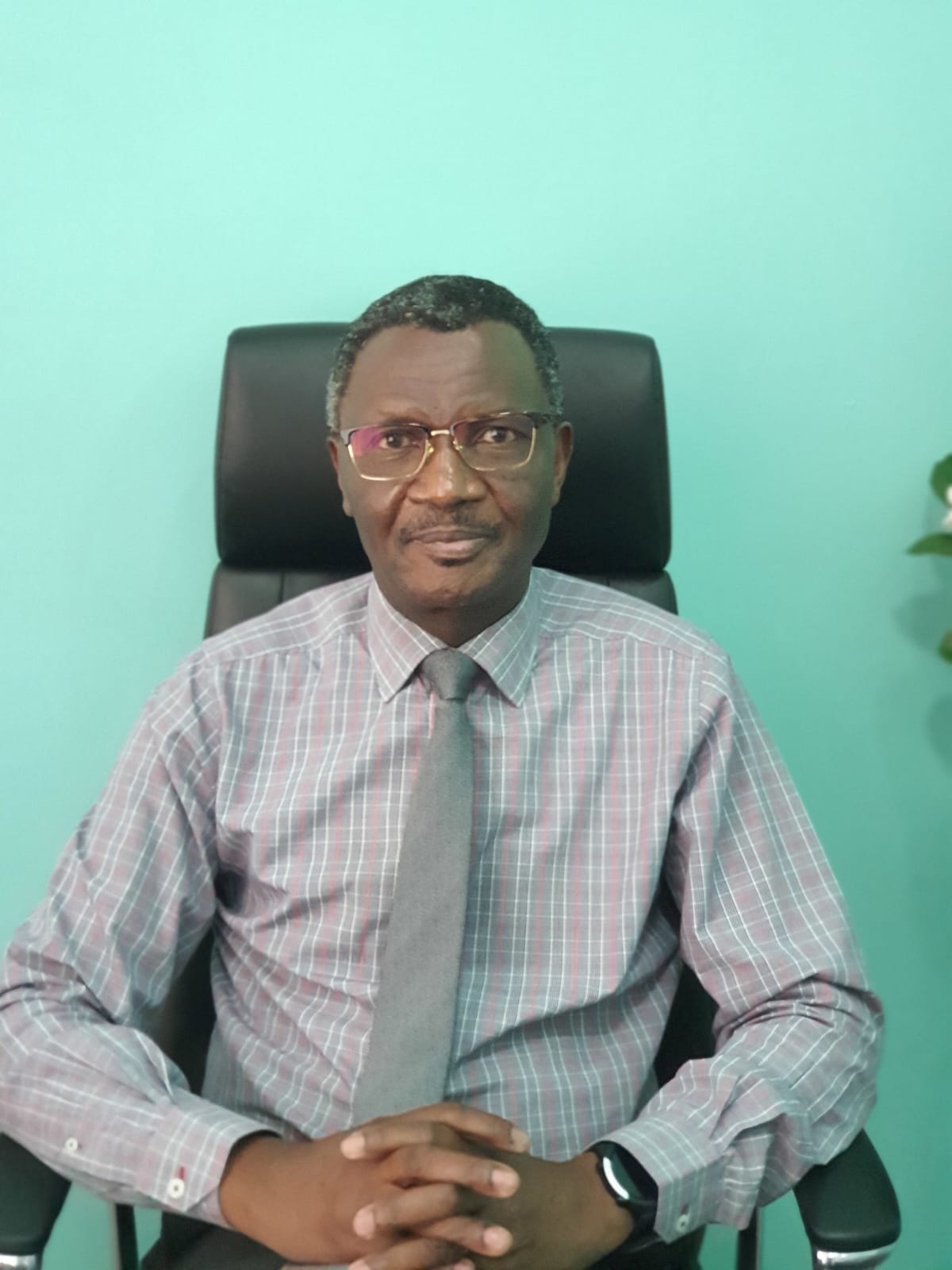 Dr. Alphonce Nabiswa seated at his consulting desk at Parklands Mindcare Centre