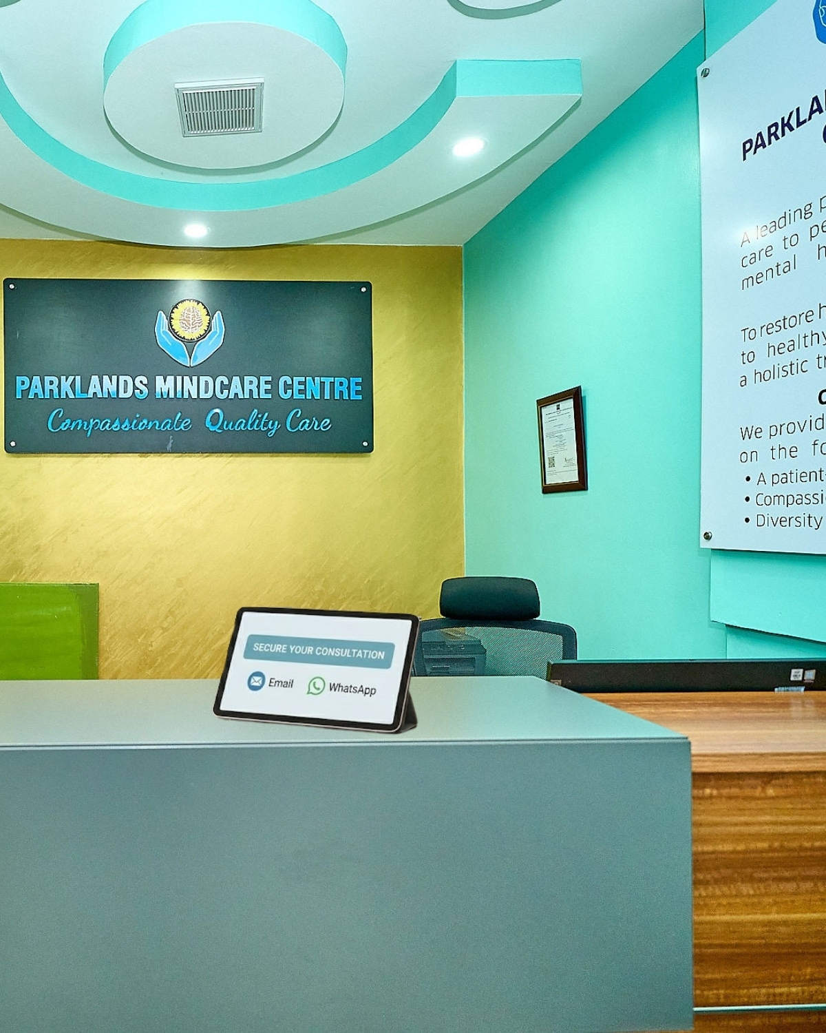 The reception desk at Parklands Mindcare Centre with the Secure Your Consultation digital booking screen visible