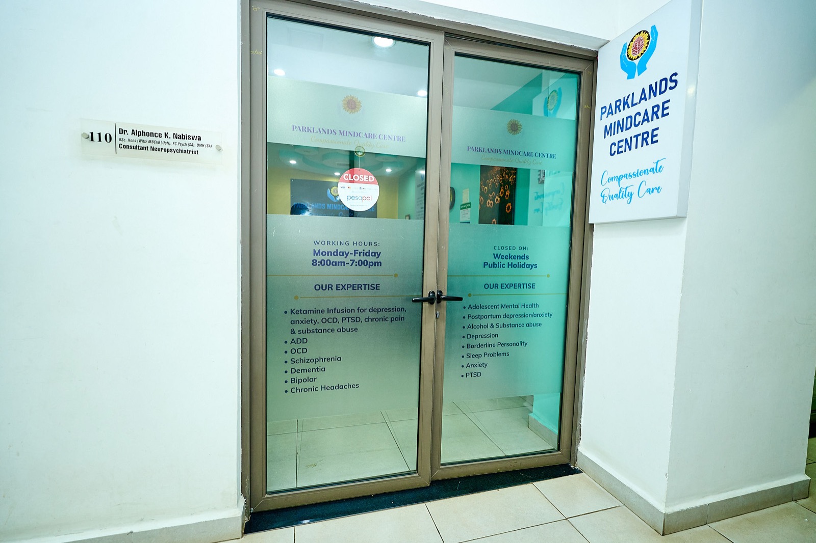 The entrance to Suite 110, Parklands Mindcare Centre, showing the conditions list on the door