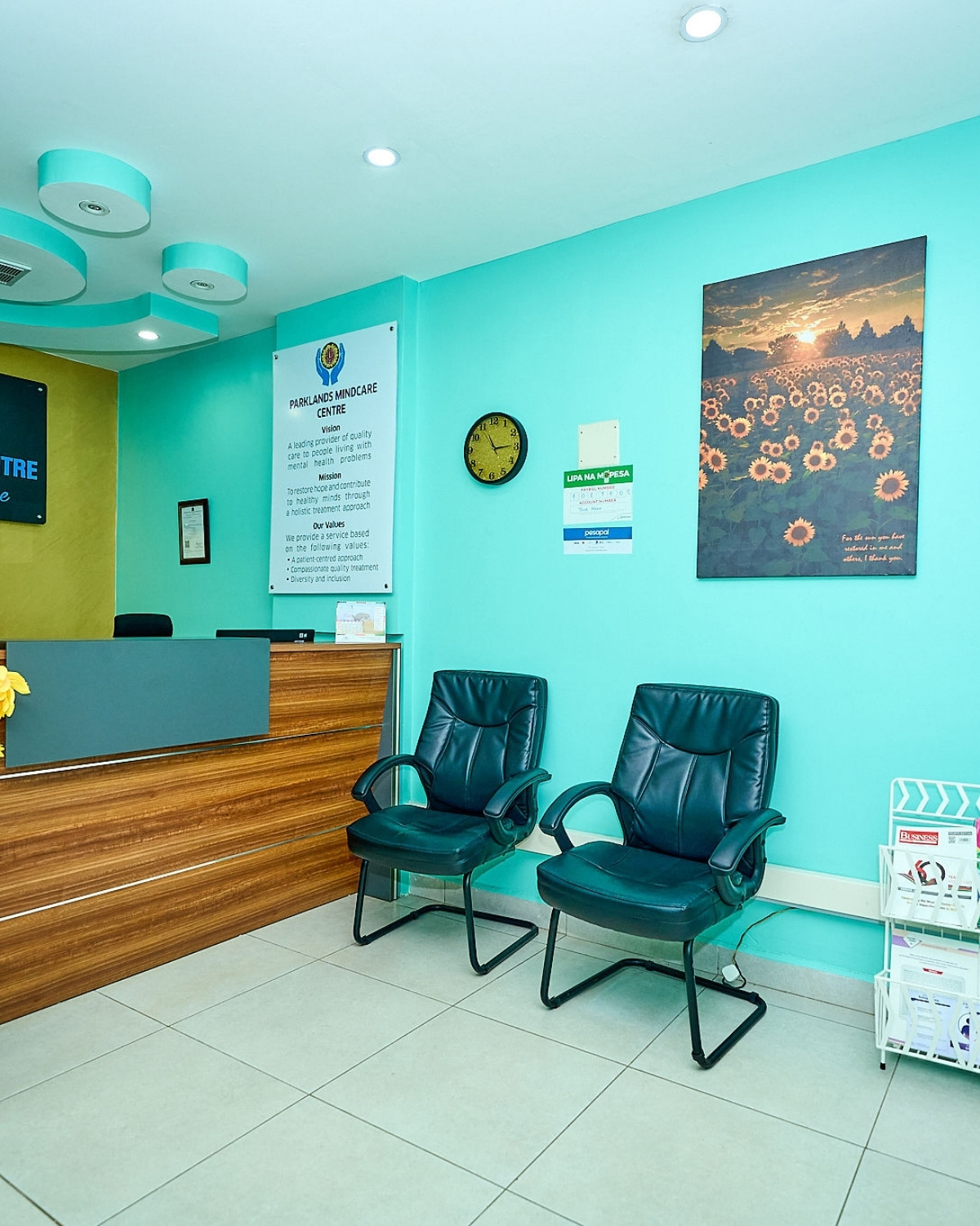 The waiting area at Parklands Mindcare Centre, with the patient seating, the sunflower artwork, and the reception desk visible alongside