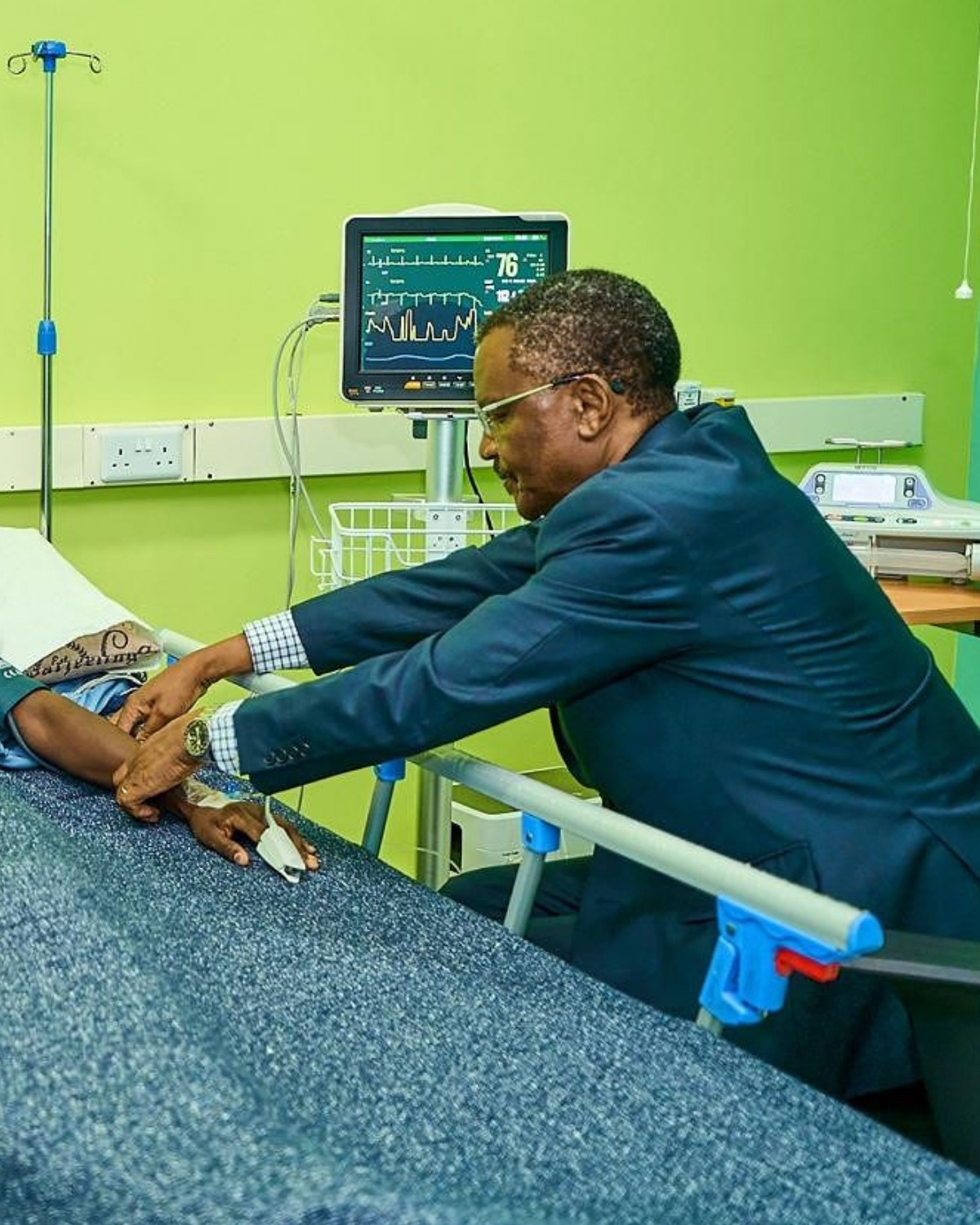 Dr. Alphonce Nabiswa attending a patient at Parklands Mindcare Centre, with a critical-care monitor visible in the background